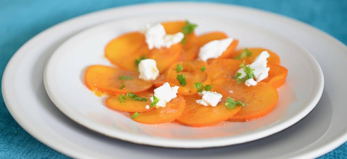 Persimmon goat cheese and roasted hazelnuts salad