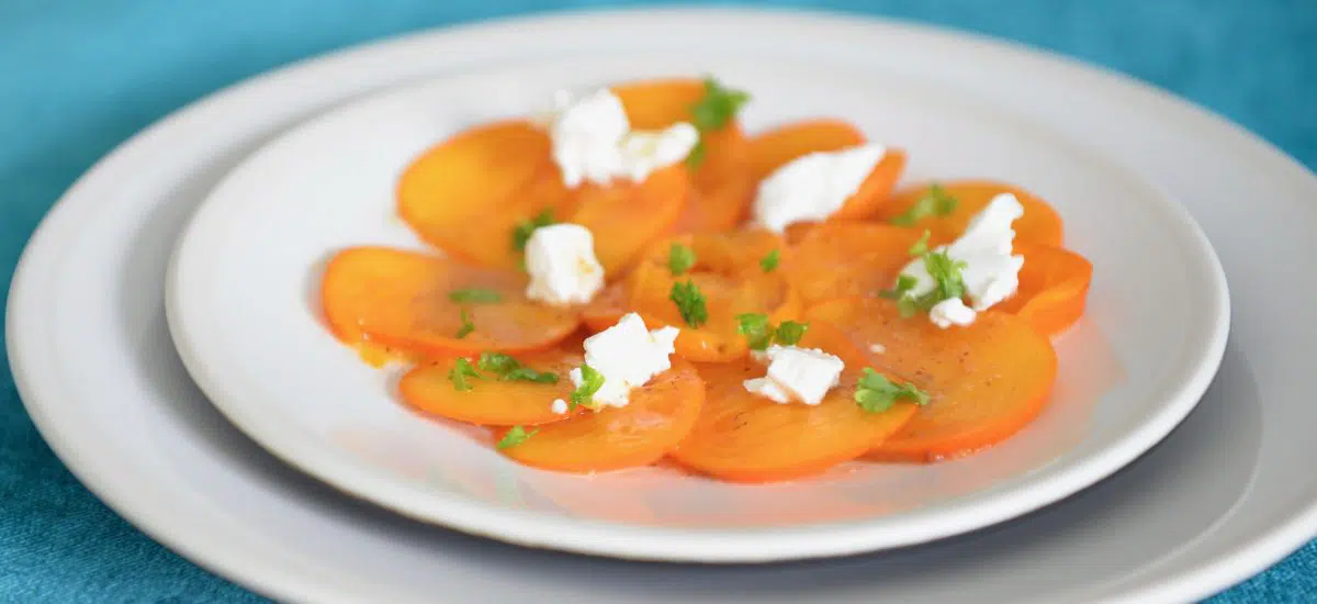 Persimmon goat cheese and roasted hazelnuts salad