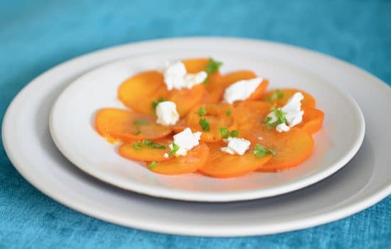 Persimmon goat cheese and roasted hazelnuts salad